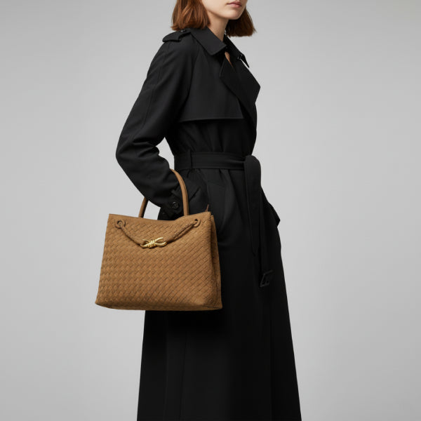 Model carrying the Veyra vegan leather tote bag in caramel color, styled with a sophisticated outfit, showcasing its modern design