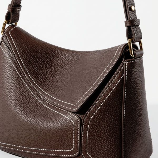 Close-up of Virella coffee brown leather hobo bag with gold hardware and white stitching details