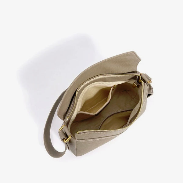 Interior of Virella beige leather hobo bag showing compartments and a zipped pocket for organized storage
