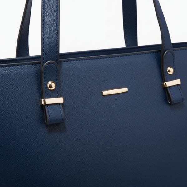 Close-up of the Vivienne vegan leather tote bag in navy blue, showcasing the elegant gold-tone accents and structured straps