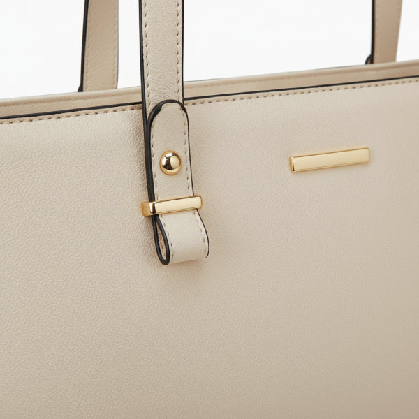 Close-up of the Vivienne vegan leather tote bag in off-white, showcasing the elegant design with gold-tone accents and sleek straps