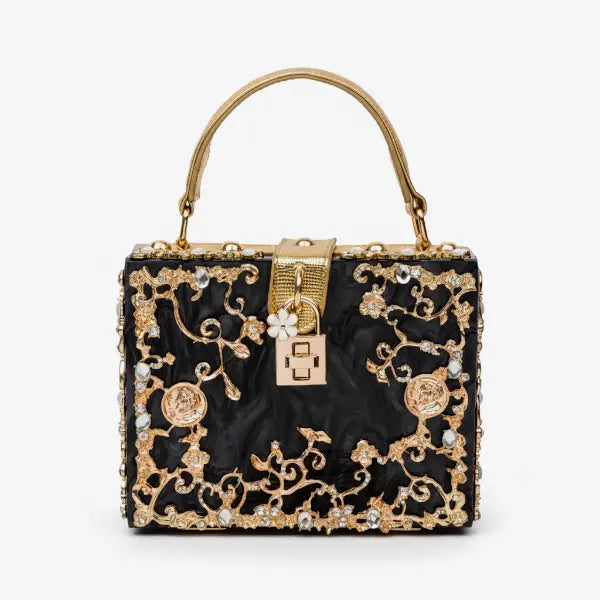 Front view of Zephyra acrylic evening bag in black with gold floral details and decorative clasp