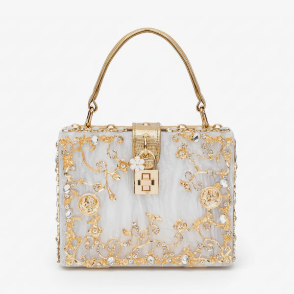 Front view of Zephyra acrylic evening bag in white with gold floral embellishments and lock clasp