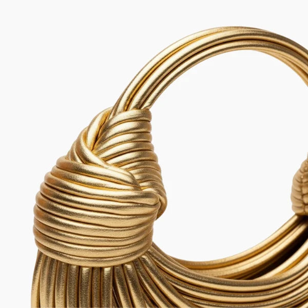 Zyra Vegan Leather Evening Bag in gold, closeup of sculptural knotted handle and wrapped cord detailing